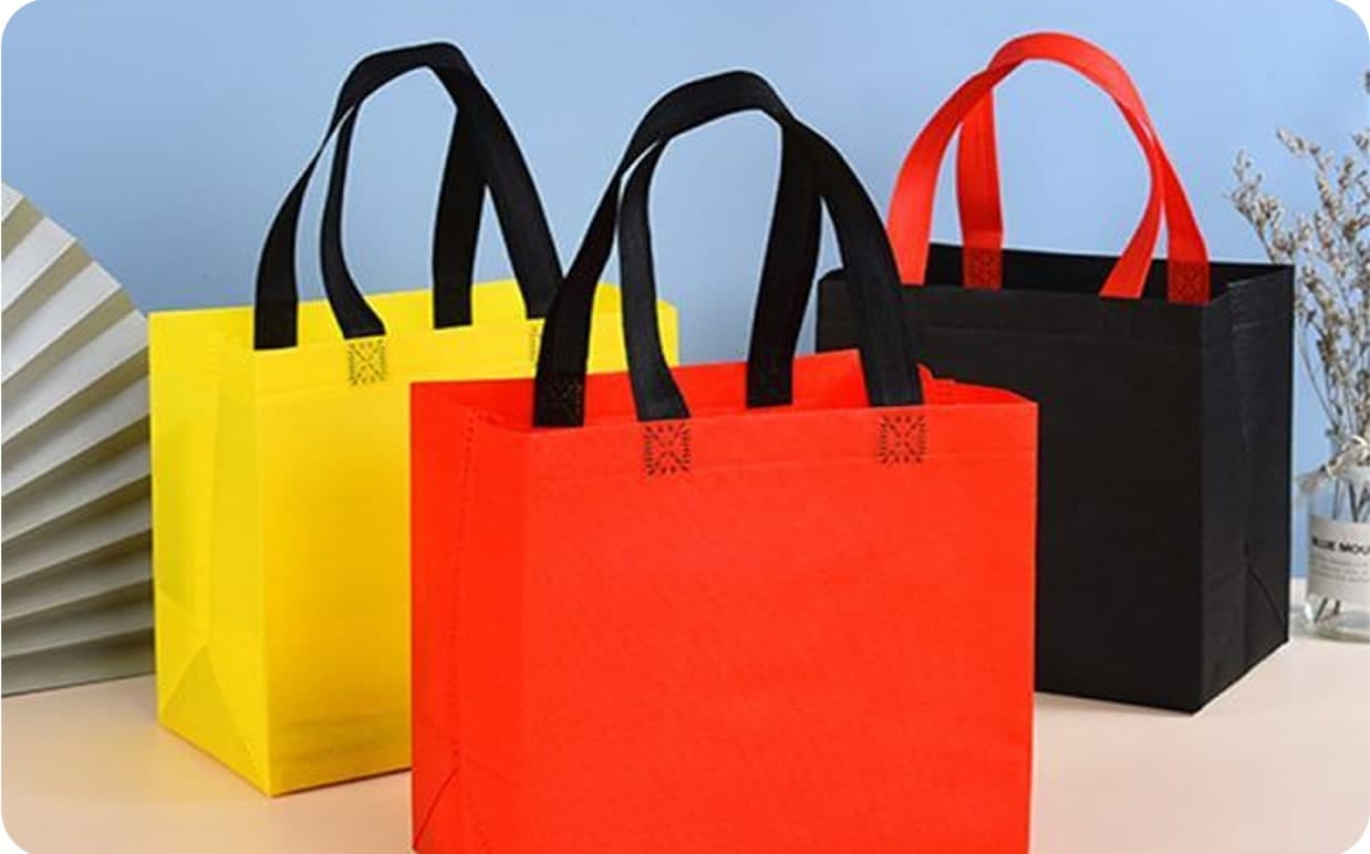 Yellow, red and black non woven bags on a table