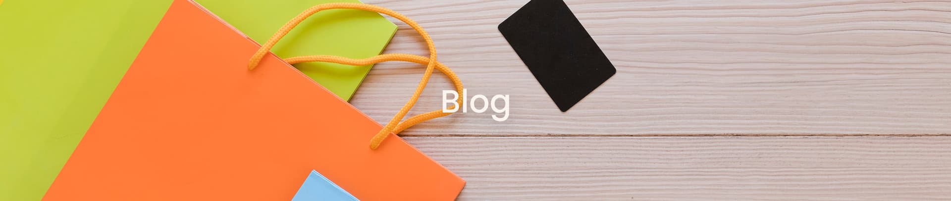Orange and green paper bags on a wooden desk – New Priya Printers blog